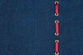 Red silk ribbon is inserted in a dark denim fabric. With place for your text.