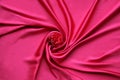 Red Silk And Rose Petals. rose on a silk textured abstract background. Valentines day with copy space for add text Royalty Free Stock Photo