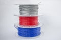 Red, silver and blue plastic filament coils for 3d