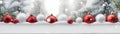 Red and silver Christmas balls in a row with white trees covered with snow. Royalty Free Stock Photo