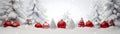 Red and silver Christmas balls in a row with white trees covered with snow. Royalty Free Stock Photo