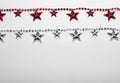 Red and silver star garland on white backgroun. Flat lay. Top view