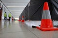 Red, silver witches hat cone traffic warning sign barrier applying on walkway pedestrian footpath building under construction