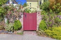 Red single concave wooden gate with arched arbor and bricks posts at San Francisco, California Royalty Free Stock Photo