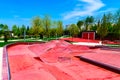 Red skate, roller and bike park with tubes, springboard and jumps