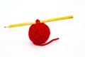 Red skein of thread with the pencil against white background. Red ball of woollen red thread isolated on white Royalty Free Stock Photo