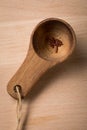 Red skinned rice in portion spoon on wooden background as symbol for hunger, famine, poverty or diet and healthy nutrition