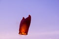 Red sky lantern flying against a blue sky