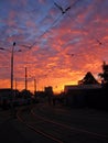 Red sky, sundown time. Dark street lanterns, tramway Royalty Free Stock Photo