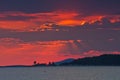 Red sky at sunset over sea with small cape in background, Sithonia Royalty Free Stock Photo