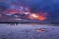 Red sky sunset over snowy Poole beach Royalty Free Stock Photo