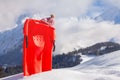 Red sledge in snow over the mountain with pink kids hat Royalty Free Stock Photo