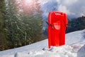 Red sledge in snow over the mountain range and forest Royalty Free Stock Photo