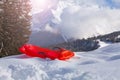 Red sledge in snow over the mountain - winter vacation still Royalty Free Stock Photo