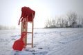 Red Sledge and warm trousers in snow landscape Royalty Free Stock Photo