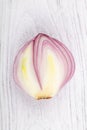 Red slice onion bulb on white wood table