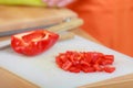 Red sliced pepper with knife on cutting board Royalty Free Stock Photo