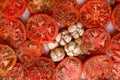 Tomatoes sprinkled with spices and garlic before baking
