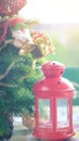 Red small candle lantern on the table decorative with Santa Claus dall and present box hanging on Christmas Tree, Christmas day Royalty Free Stock Photo