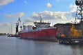 Red small cargo offshore and supply ship being repaired in shiprepairing yard Royalty Free Stock Photo