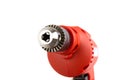 Red Small Electric drill machine with drill bit.