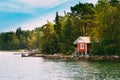 Red Small Finnish Wooden Sauna Log Cabin On Island In Autumn Sea