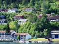 red small houses Norwegian village, fjord background Royalty Free Stock Photo