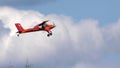 Red small sport plane flying in the sky pulls on a rope the glider plane Royalty Free Stock Photo