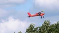 Red small sport plane flying in the sky pulls on a rope the glider plane Royalty Free Stock Photo