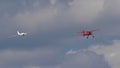 Red small sport plane flying in the sky pulls on a rope the glider plane Royalty Free Stock Photo