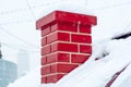 Red smoke brick pipe, chimney close-up, on the roof of a snow-covered house. Symbol of the New Year holidays, Royalty Free Stock Photo