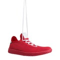 Red sneaker made of mesh fabric, hung on laces, concept, on a white background Royalty Free Stock Photo