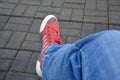 Red sneakers, legs of a young man