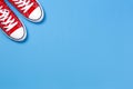 Red sneakers on light blue background, top view Royalty Free Stock Photo