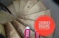 Red sneakers on spiral staircase when going downhill with inscription in german Cookies DSGVO-konform in english Cookies GDPR comp