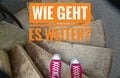 Red sneakers on spiral staircase when going downhill and the inscription in german Wie geht es weiter? in english Whats next? Royalty Free Stock Photo