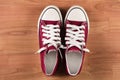 Red sneakers top view close up on wooden background Royalty Free Stock Photo