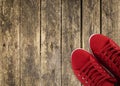 Red sneakers on wooden deck Royalty Free Stock Photo