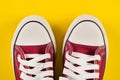 Retro Vibes: Red Sneakers on Yellow Background - Fashion and Style Revival Royalty Free Stock Photo