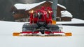 A red snowcat or snow groomer in action Royalty Free Stock Photo