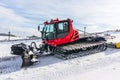 Red snow-grooming machine on snow Royalty Free Stock Photo