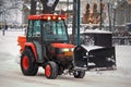 Red Snow Removal Tractor in City Royalty Free Stock Photo