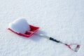 Red snow shovel lying in the snow Royalty Free Stock Photo