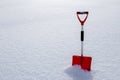 Red snow shovel standing in the snow Royalty Free Stock Photo