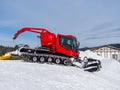 A red snowcat at a ski resort is preparing to tamp the snow Royalty Free Stock Photo