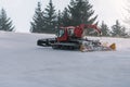 Red snowcat on snow in the winter in mountains Royalty Free Stock Photo