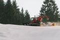 Red snowcat on snow in the winter in mountains Royalty Free Stock Photo