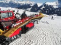 Red snowcat waits to groom the snow Royalty Free Stock Photo