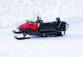 Red Snowmobile ski-doo. Skidoos parking in the snow-white yard.