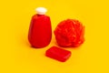 Red soap, shampoo bottle, bath foam on a yellow background Royalty Free Stock Photo